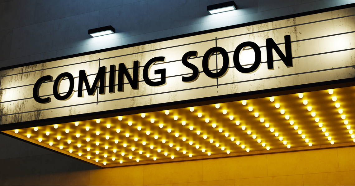 A 'marquee' sign outside a cinema or theatre with the words 'Coming soon'.