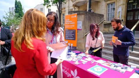 Council officers speaking to members of the public outside the town hall