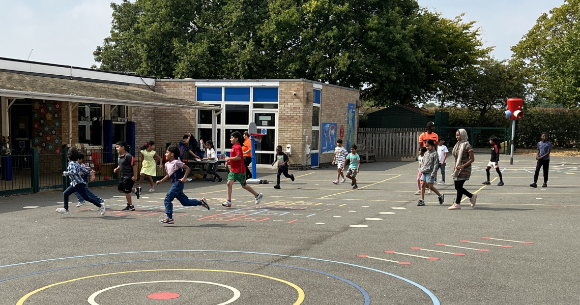 Children running across school playground