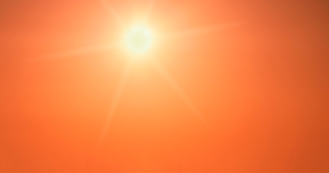 An image of the sun in a bright sky. 