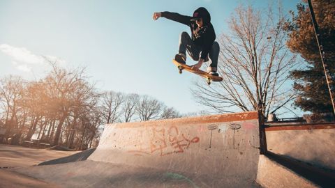 A skateboarder getting totally rad air over a quarter pipe
