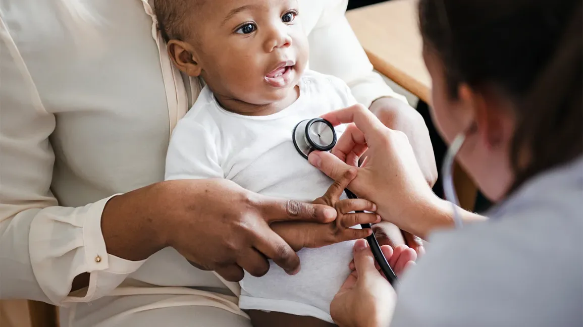 A doctor examines a baby